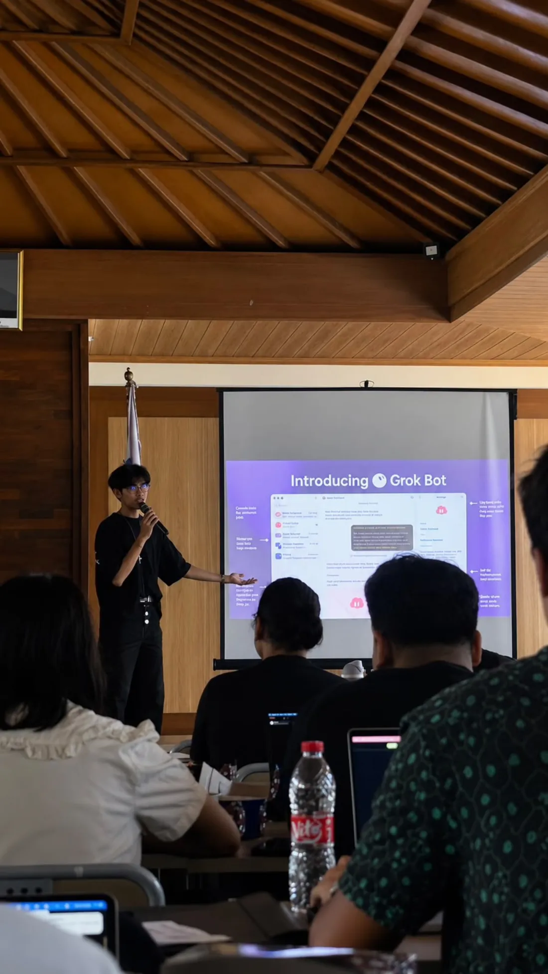 Treshnanda presenting “Introducing Grok Bot” to a room of builders with laptops
